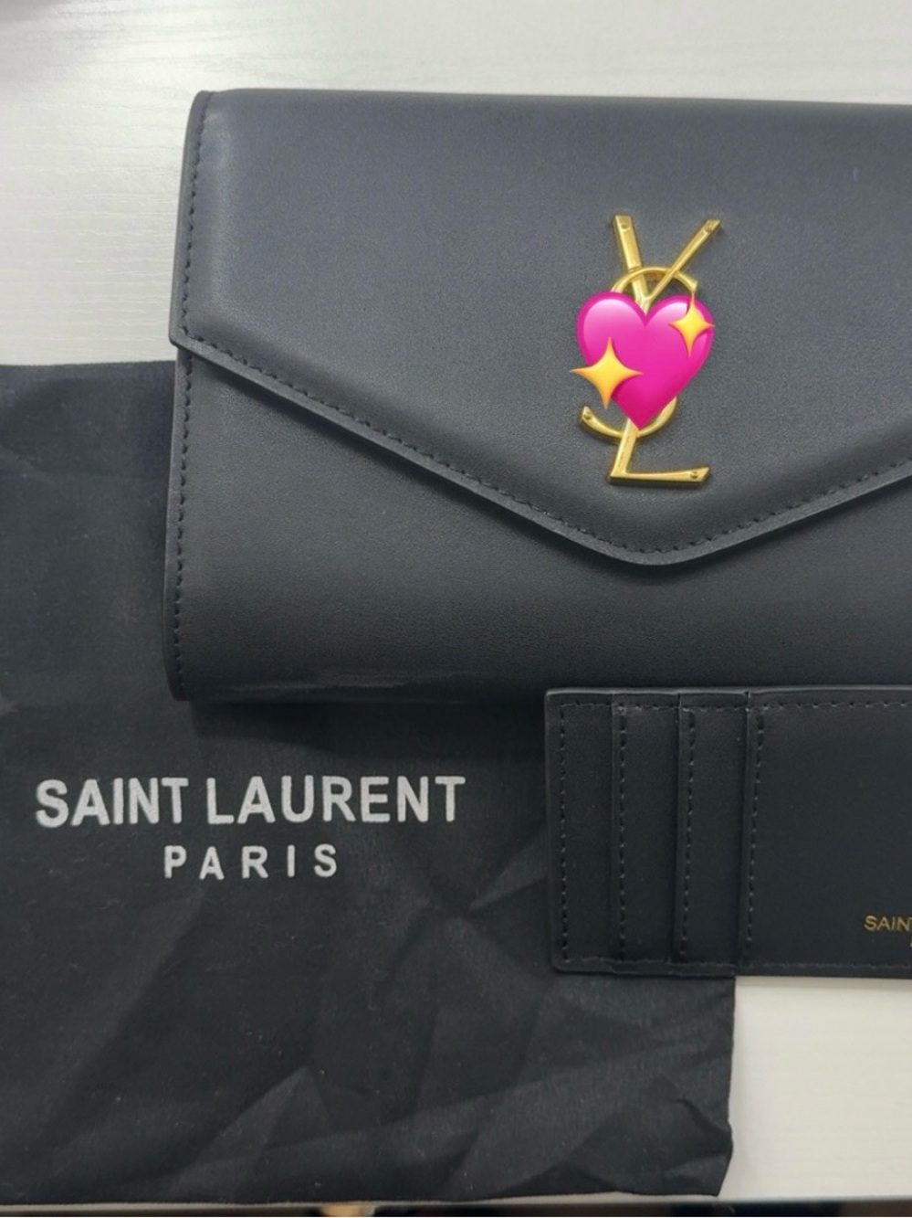 Elegant black wallet on a chain with gold hardware